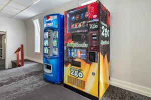 a video game vending machine next to two soda machines at Amwell Suites Somerset/Bridgewater 