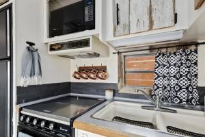 a kitchen with a sink and a stove at #StayinMyDistrict Twin Falls Backyard Glamper in Twin Falls