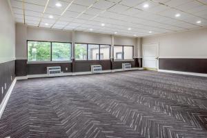 a large room with a large carpeted room with windows at Amwell Suites Somerset/Bridgewater 