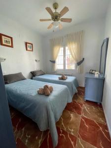 a bedroom with two beds and a ceiling fan at Traditional Villa with Private Pool SM591 in San Miguel de Salinas