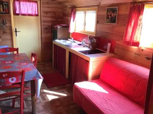 a room with a kitchen and a table with a sink at Les Roulottes du Petit Brimeux in Brimeux +18 photos