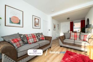 a living room with two couches and a red rug at Heart of City, 3 Bed House By Broad Meadow Stays Short Lets and Serviced Accommodation Lincoln With Free Wi-Fi in Lincolnshire