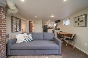 a living room with a blue couch and a kitchen at #StayinMyDistrict Pendelton Place Walk to Mt Tabor in Portland