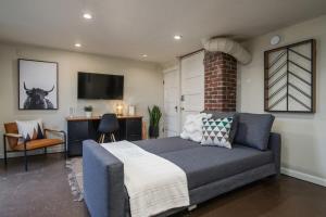 a bedroom with a bed and a desk and a television at #StayinMyDistrict Pendelton Place Walk to Mt Tabor in Portland