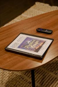 a tablet on a table next to a remote control at #StayInMyDistrict Piedmont Near Parks and Shopping in Portland