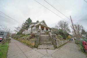 a house on a hill with stairs in front of it at #StayinMyDistrict Pendelton Place Walk to Mt Tabor in Portland