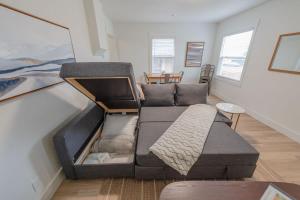 a living room with a couch and a table at #StayInMyDistrict Indigo Cottage Coos Bay in Coos Bay