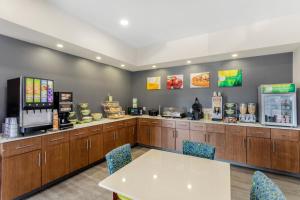 a restaurant with a table and chairs and a counter at Quality Inn & Suites in Monterey