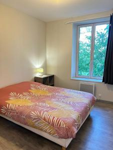 a bedroom with a bed with a colorful bedspread at A&J Family - Neuvy sur Loire - Guédelon in Neuvy-sur-Loire