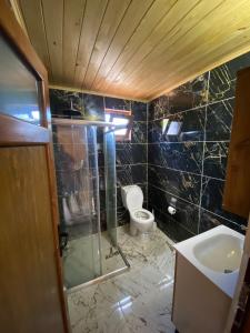 a bathroom with a shower and a toilet and a sink at Anka Bungalov Hotel in Kemer