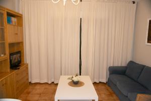 a living room with a couch and a table at Disan 3B in Portonovo