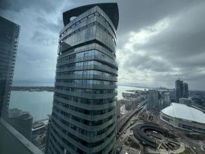 a tall glass building with a view of a city at Prime Stay Suites in Toronto