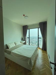a bedroom with a bed and a large window at Feliz apartment 1Br ThanhMyLoi in Ho Chi Minh City +33 photos
