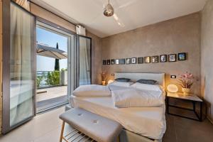a bedroom with two beds and a balcony at Villa Artista in Gardone Riviera +36 photos