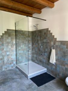 a bathroom with a shower with a glass shower stall at B&B Casa Contento in Arcevia