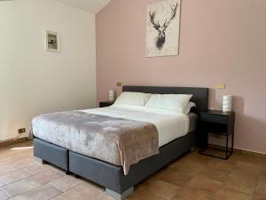 a bedroom with a bed with a deer on the wall at B&B Casa Contento in Arcevia