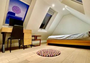 a bedroom with a bed and a desk and a rug at Welcome To Your Home in London