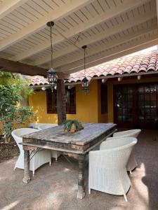 a wooden table and chairs on a patio at Sun Reef Village on Sea in Willemstad +73 photos