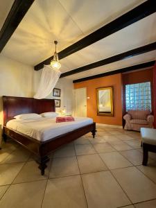 a large bedroom with a bed and a couch at Sun Reef Village on Sea in Willemstad