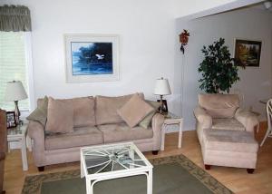 a living room with a couch and two chairs and a table at Heron Lake 3232 in North Myrtle Beach +8 photos