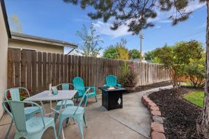 a patio with chairs and a table and a fence at #StayinMyDistrict Twin Falls Pendleton Chic Suite in Twin Falls