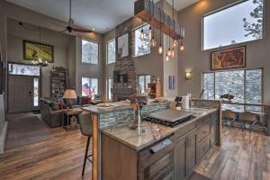 a kitchen with a counter and a living room at Coyote Cottage Retreat Hot Tub Deck Mtn Views in Black Hawk