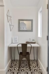 a table and a chair in a room at #StayinMyDistrictTwinFalls Tudor in Twin Falls