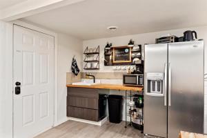 a kitchen with a stainless steel refrigerator and a counter at #StayInMyDistrict TwinFalls Apartment in Twin Falls