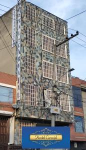 um edifício de pedra com um sinal em frente em Hostal Carvajal em Bogotá