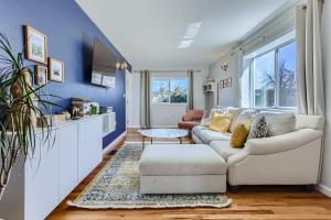 a living room with a white couch and blue walls at 3BD Family Friendly Walk to Huston Lake in Denver