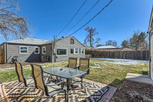 a patio with a table and chairs in front of a house at 3BD Family Friendly Walk to Huston Lake in Denver