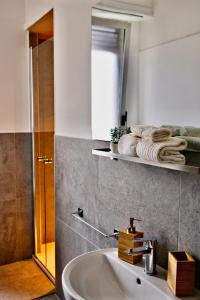 a bathroom with a sink and a mirror and a shower at La Casa di Cloe in La Spezia