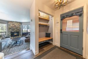 a room with a door and a living room with a fireplace at Stylish 2BD Condo - Walk to Palisades! in Olympic Valley