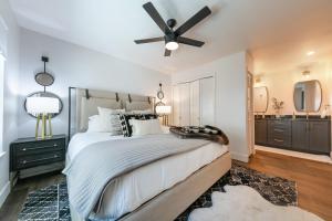 a bedroom with a large bed with a ceiling fan at Stylish 2BD Condo - Walk to Palisades! in Olympic Valley