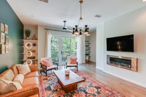 a living room with a couch and a table at Pet-Friendly Nashville Townhouse with Private Deck! in Nashville