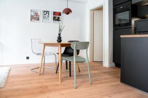 a dining room table and chairs in a kitchen at Renovated Chic Studio 5 Min to City Center in Luxembourg