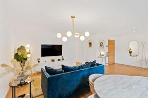 a living room with a blue couch and a table at Chic Apt Close to Kirchberg Shopping Centre ID157 in Luxembourg