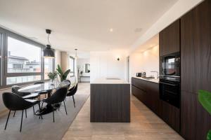 a kitchen and dining room with a table and chairs at City Luxury with City Views in Ville Haute ID174 in Luxembourg