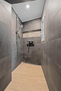 a bathroom with a shower with a glass door at Elegant 1BR Retreat in Peaceful Grund in Luxembourg