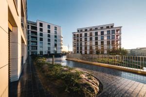 a view of two buildings in a city with water at Prime Location Modern Gem in Gasperich in Luxembourg