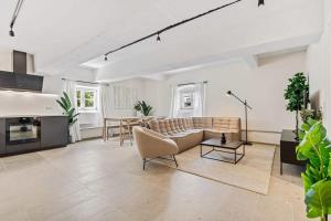 a living room with a couch and a table at Clausen Charm Contemporary Retreat ID210 in Luxembourg