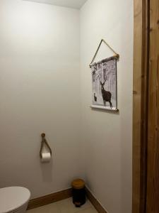 a bathroom with a picture of a deer on the wall at Chalet Martin Belle-Vue in Aime-La Plagne +30 photos