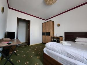 a hotel room with a bed and a desk and a desk at Heyvah - Guest House in Tashkent in Tashkent