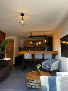 a kitchen and living room with a bar and chairs at Chalet Martin Belle-Vue in Aime-La Plagne