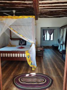 a bedroom with a bunk bed and a wooden floor at Queen of Sheba Beach Lodge in Pongwe