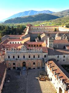 an aerial view of a building with mountains in the background at Casa Semeria Certosa di Padula(SA) in Padula