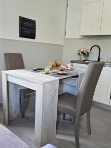 a kitchen with a table and chairs with food on it at Casa Semeria Certosa di Padula(SA) in Padula