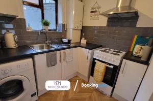 a kitchen with a stove top oven next to a sink at 3 Bedroom House By Broad Meadow Stays Short Lets and Serviced Accommodation Lincoln With Parking in Lincoln