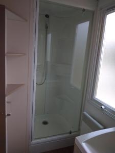 a shower with a glass door in a bathroom at Mobil Home 6 couchages in Vic-la-Gardiole