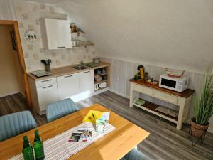 a kitchen and dining room with a table and a microwave at Ferienwohnungen Tannenhof in Willingen